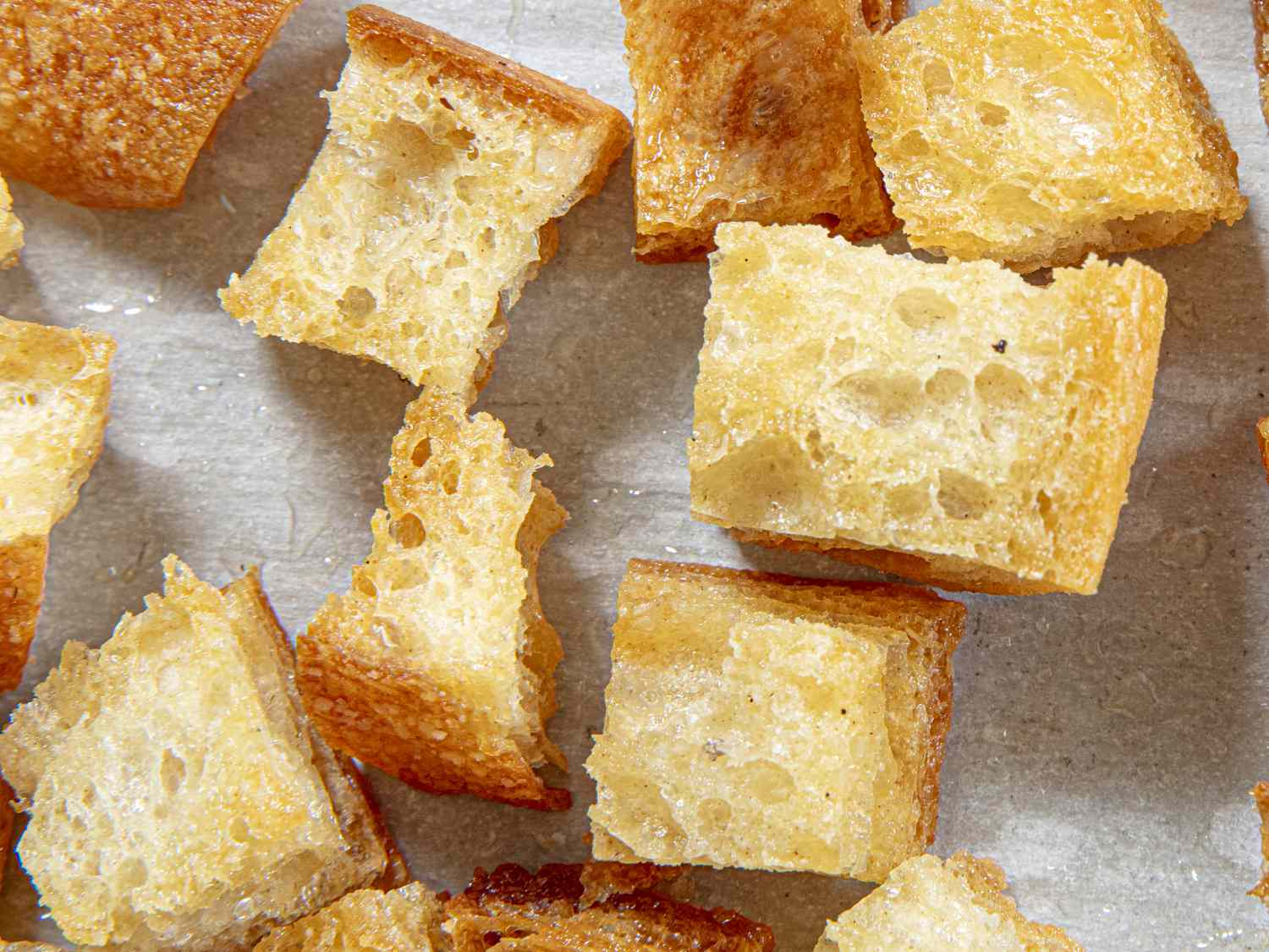 Overhead view of croutons on sheet tray