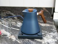 closeup of the fellow corvo kettle with an empty mug next to it