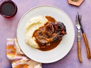 Overhead view of red-wine braised short ribs on a white plate