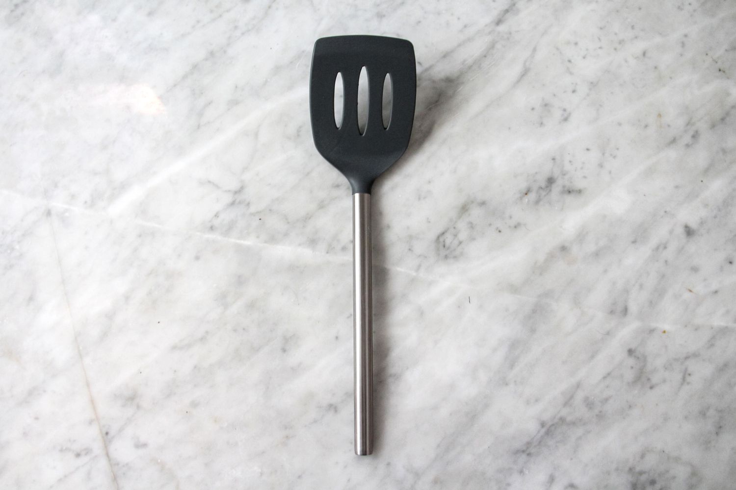 Tovolo Silicone Slotted Turner on a marbled surface