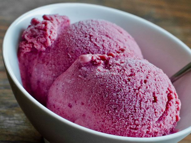 Closeup of two scoops of roasted plum, ginger, and honey ice cream, served in a small bowl.