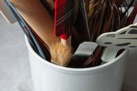 Numerous spatulas and spoons in the white Williams Sonoma utensil crock.
