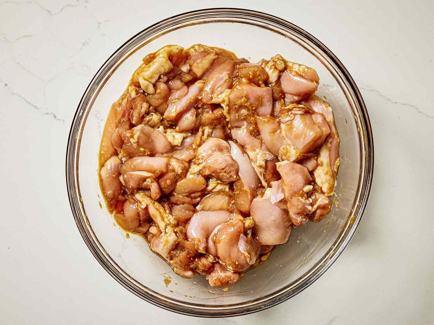 Marinated chicken in a glass bowl 
