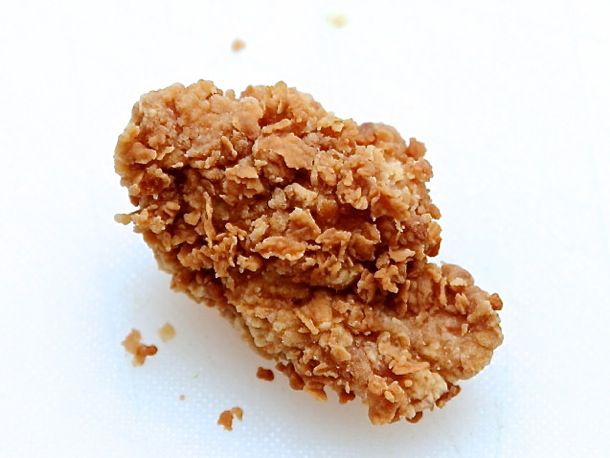 A close-up of a chunk of extra-crispy fried chicken.
