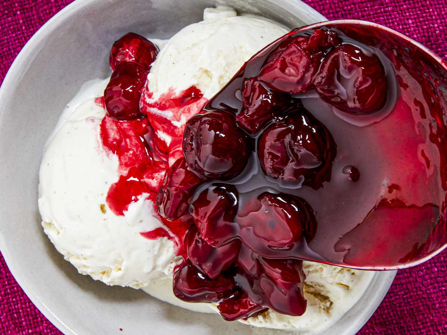 Overhead view of adding cherries to icecream 