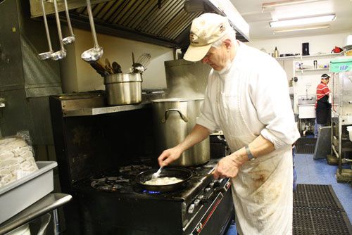 Hans master butcher at stove