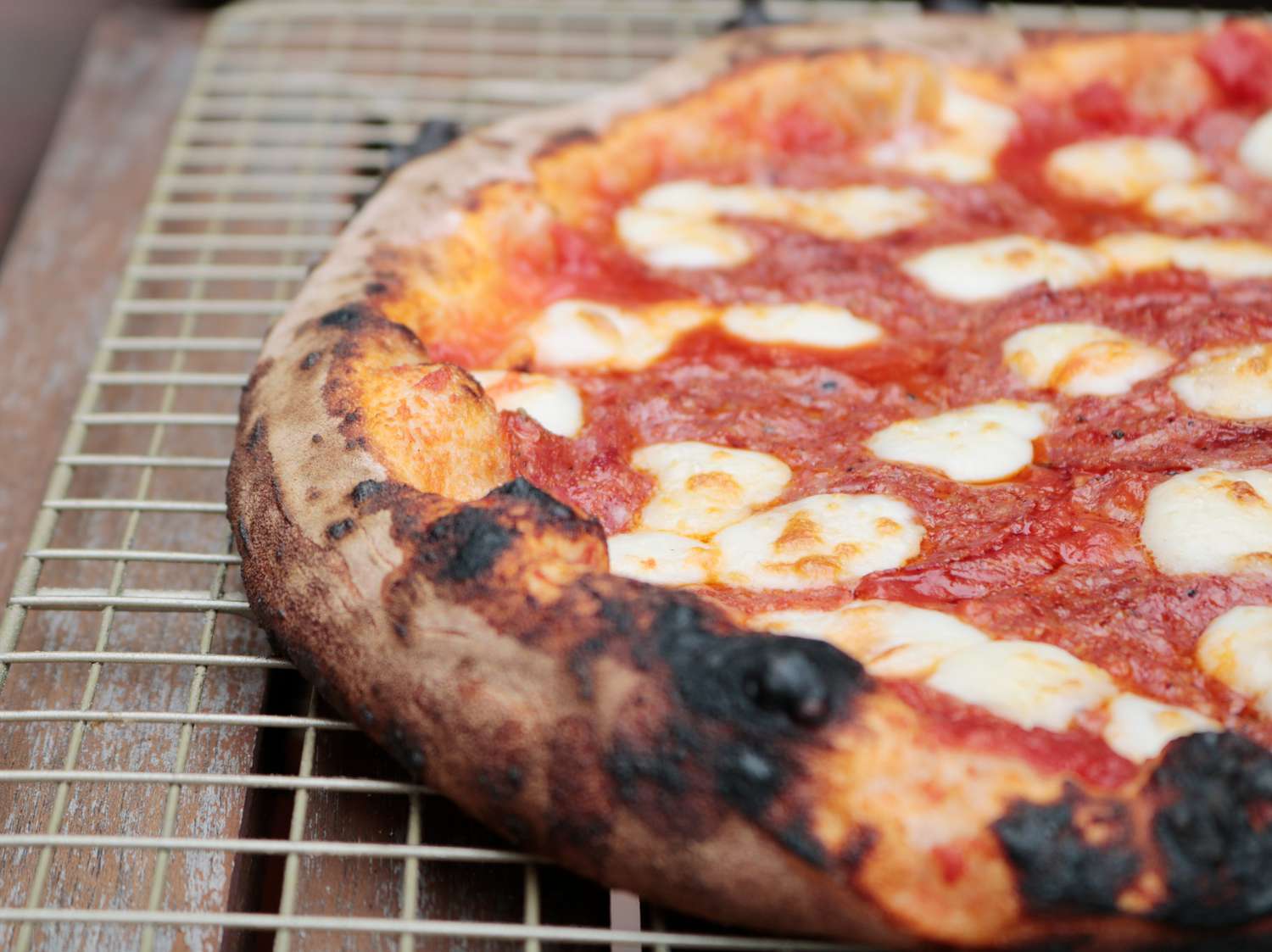 a close up of a piza with a charred crust