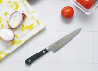 misono petty knife on a white tile surface