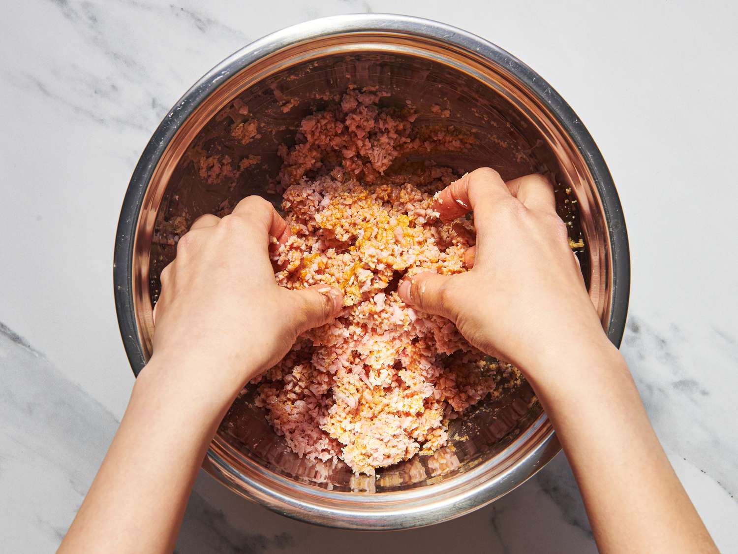 Overhead view of mixing meat mixture
