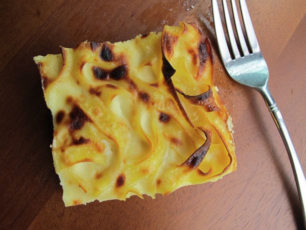 Overhead closeup of a square slice of white chocolate noodle pudding
