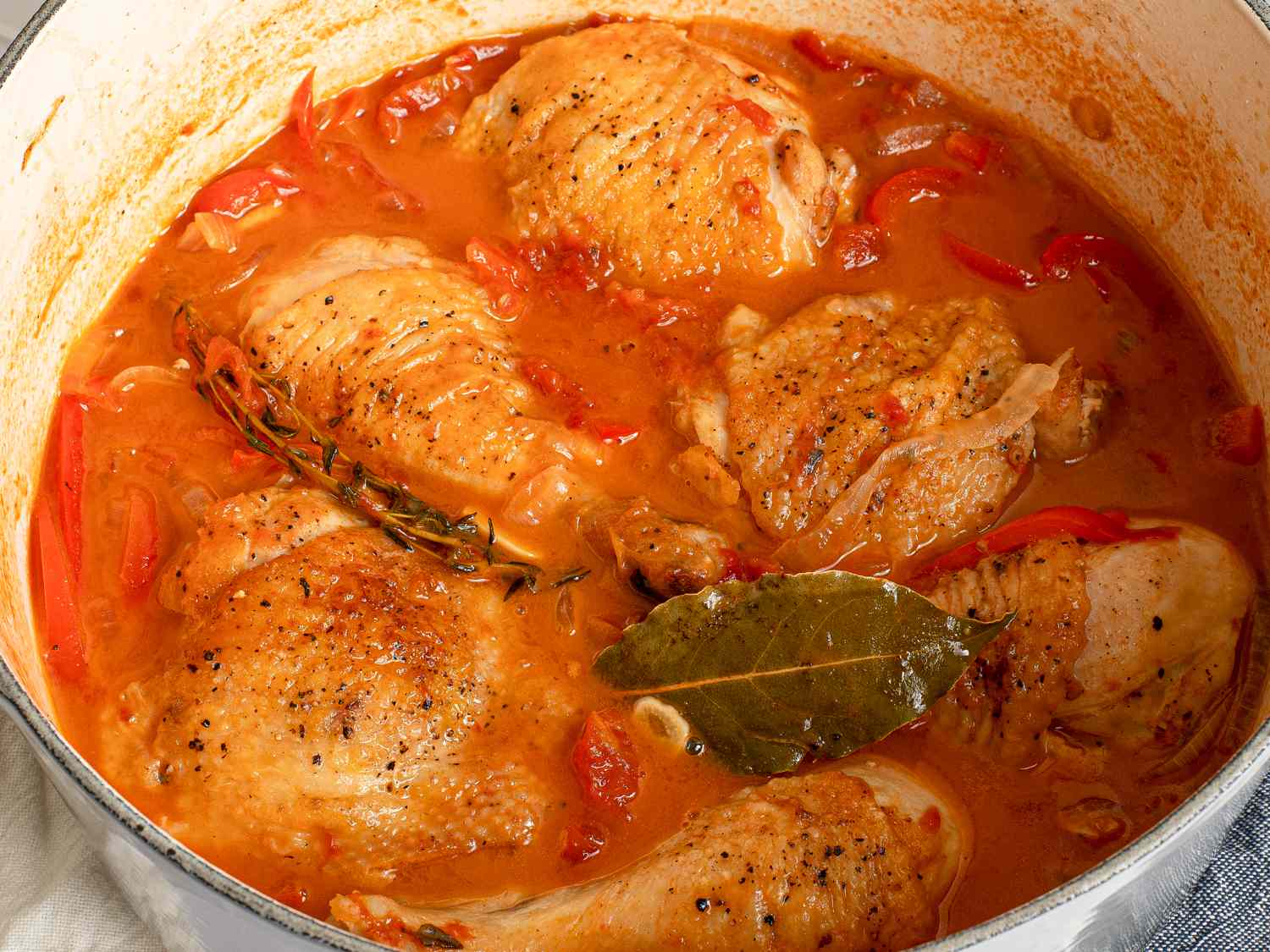 Chicken cooked and sauce slightly reduced and thickened inside of the Dutch oven.