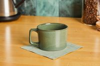 The Haand short mug on a green napkin