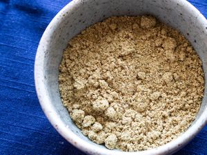 Overhead closeup of a bowl containing alguashte (Salvadoran pumpkin seed seasoning).