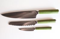 A set of three Material kitchen knives with green handles