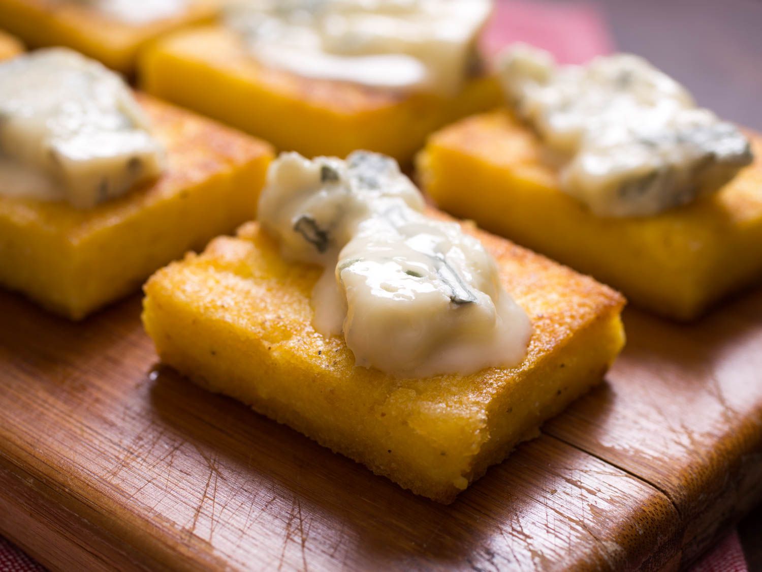 Polenta squares topped with gorgonzola dolce.