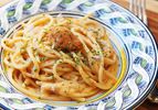 A shallow bowl of creamy sea urchin (uni) pasta with a tongue of sea urchin on top.