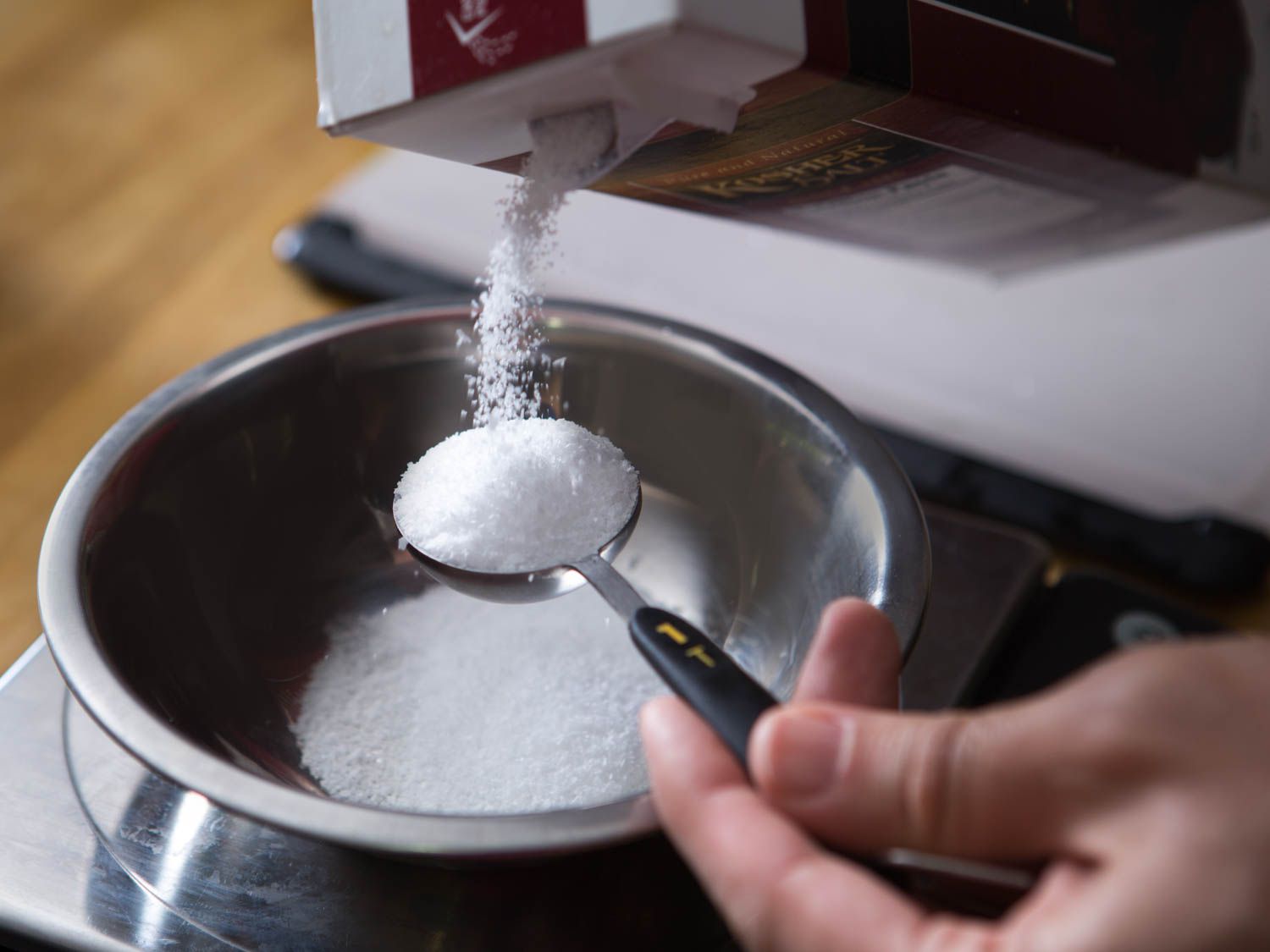 Measuring salt for gravlax cure.
