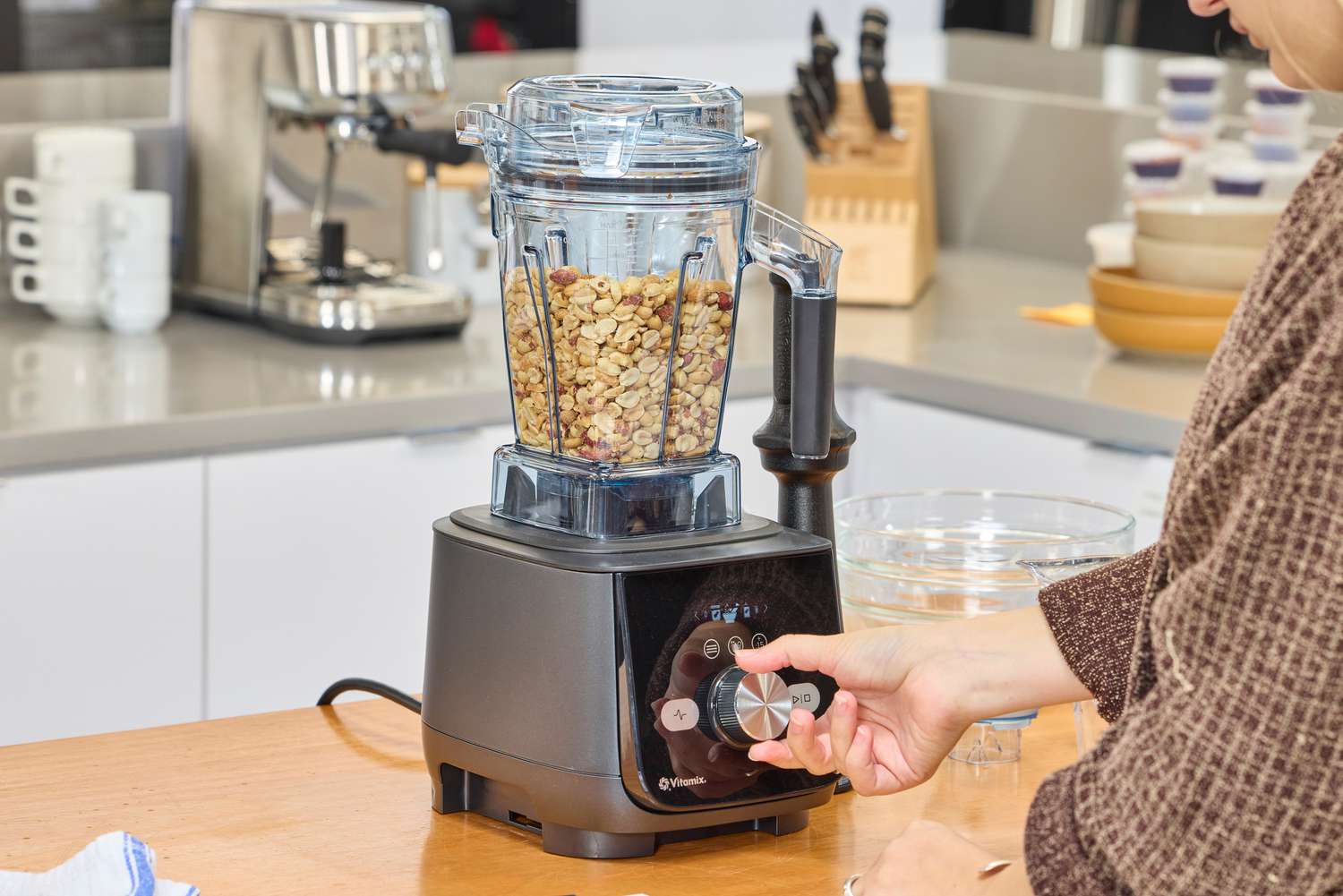 A hand turning a nob on the Vitamix Ascent X5 Blender