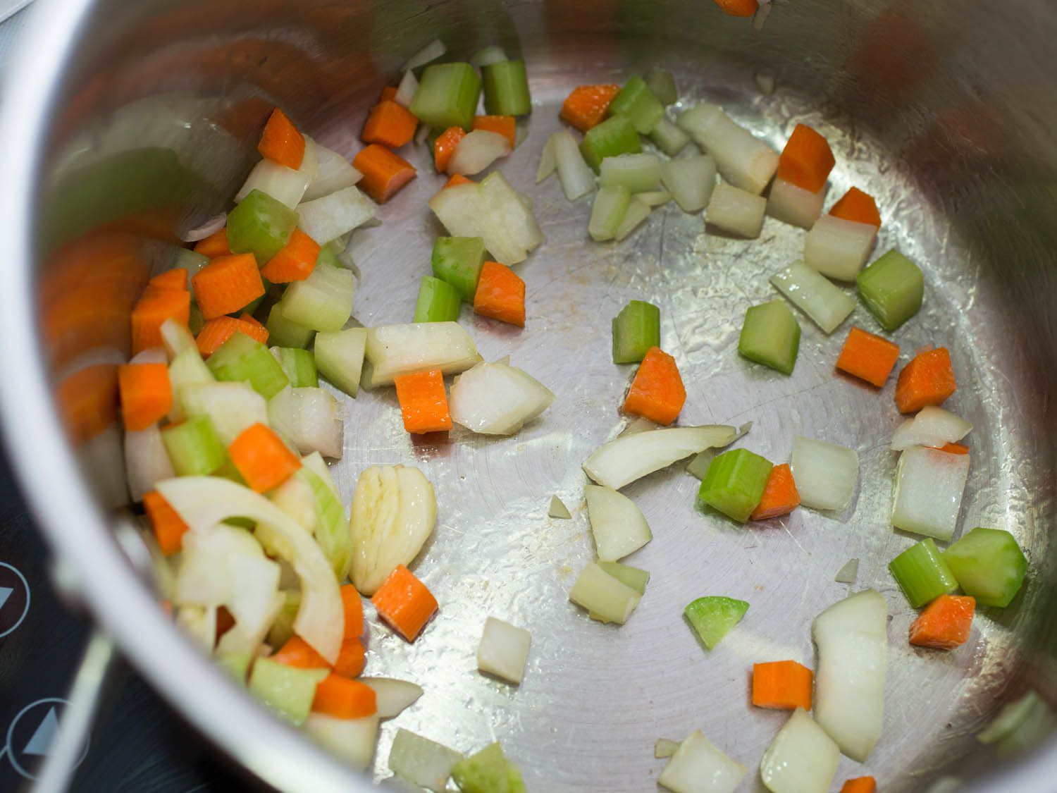 Sautéing vegetables in stock pot.