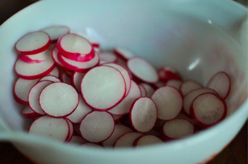 Sliced radishes in a bowl.