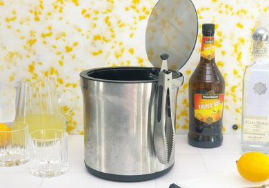 oxo ice bucket on a white tile surface