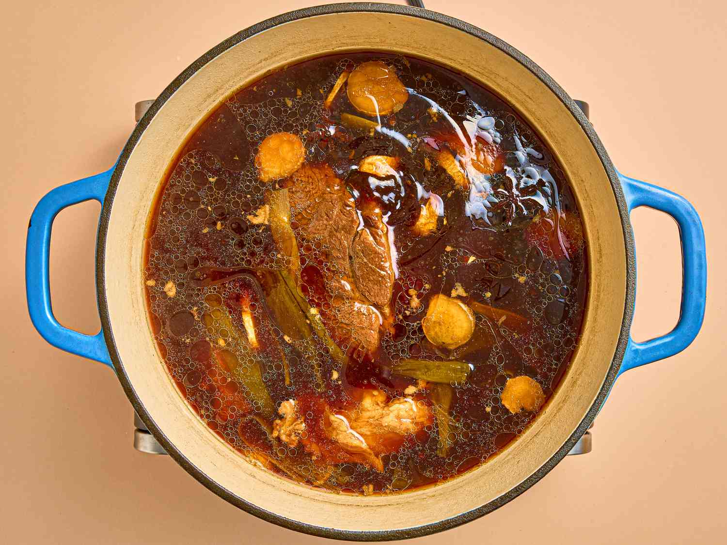 Overhead view of braising liquid in pot