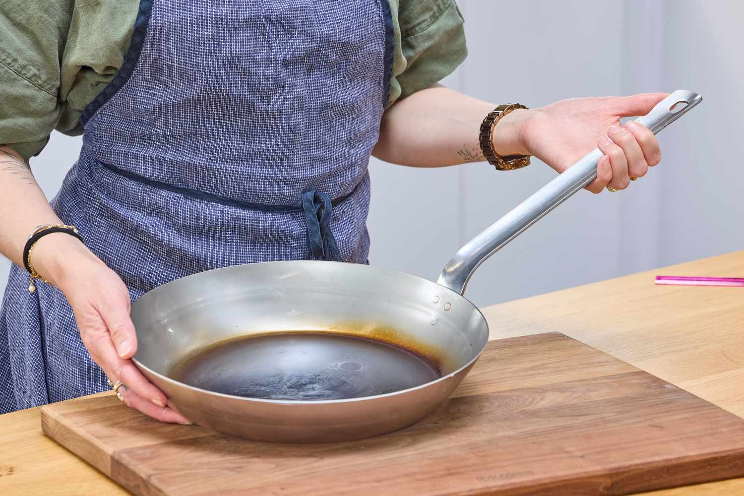 A person holds the Vollrath 12.5 Inch French Style Carbon Steel Fry Pan