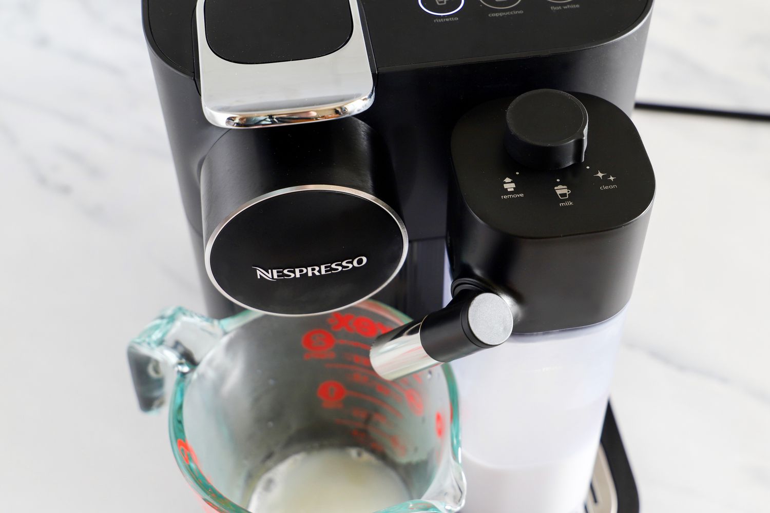 a measuring cup on the Nespresso Gran Lattissima Original Espresso Machine by De’Longhi