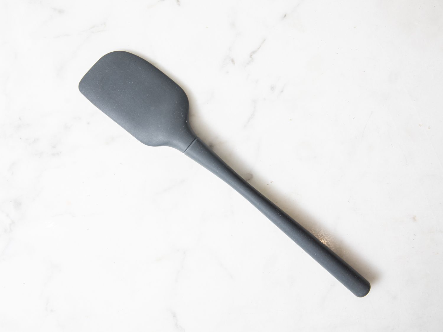 A grey Tovolo silicone spatula on a marble surface