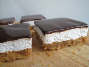 Four homemade Mallomar bars on a wood cutting board.
