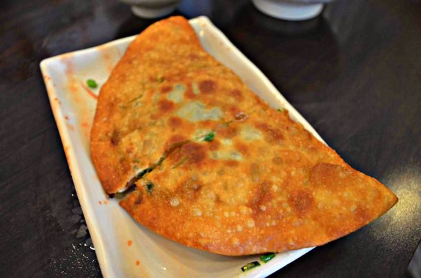 Leek pie, served on a white rectangular plate.