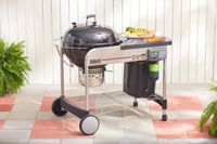 The Slow 'N Sear on a tiled patio.