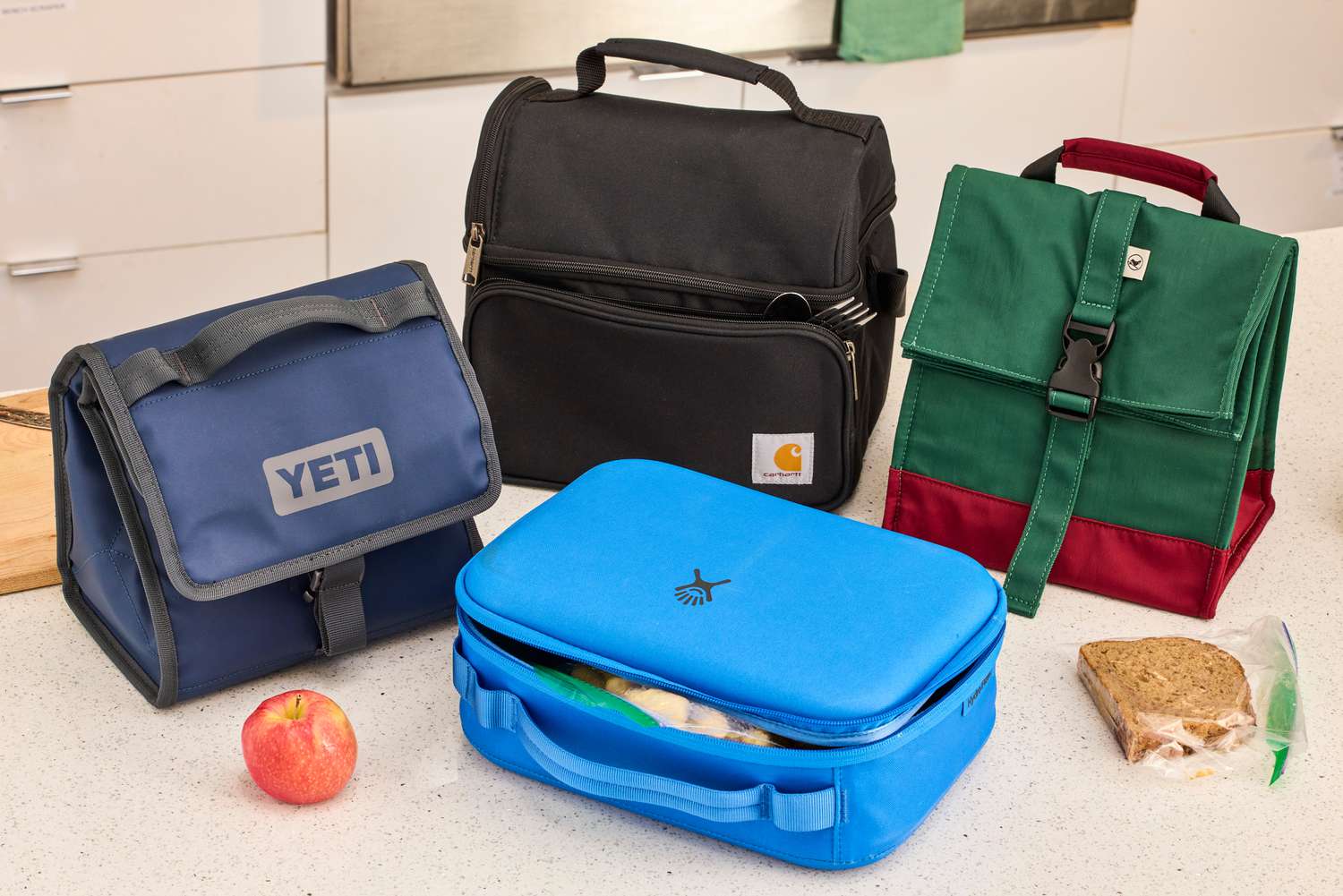 Four lunch boxes on a counter