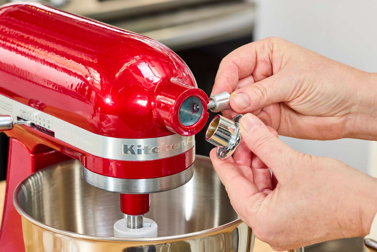 A person assembles the KitchenAid Artisan Mini 3.5-Quart Tilt-Head Stand Mixer