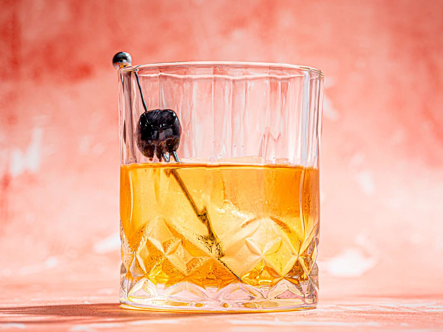 Old Fashioned shot from a low angle on a pink background