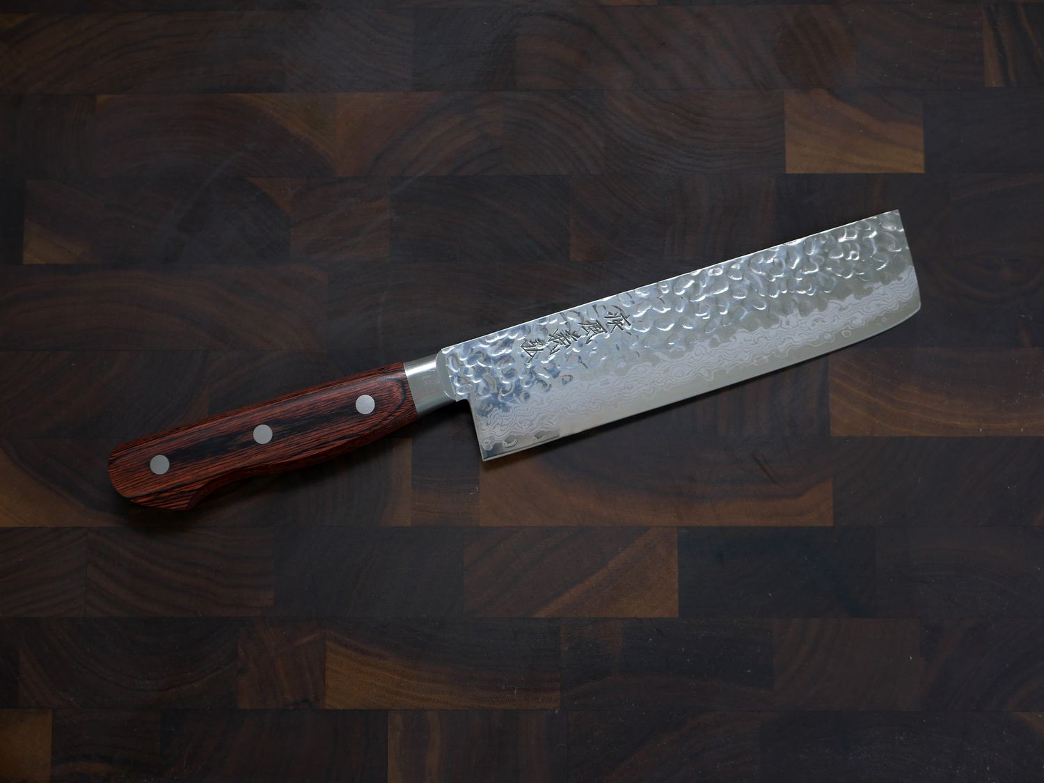 yoshihiro nakiri on a wooden cutting board 