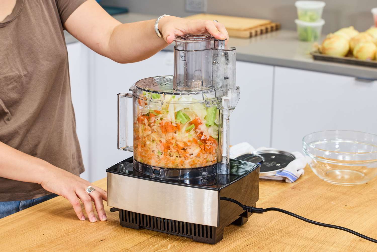 A person chops vegetables in the Cuisinart 14-Cup Food Processor
