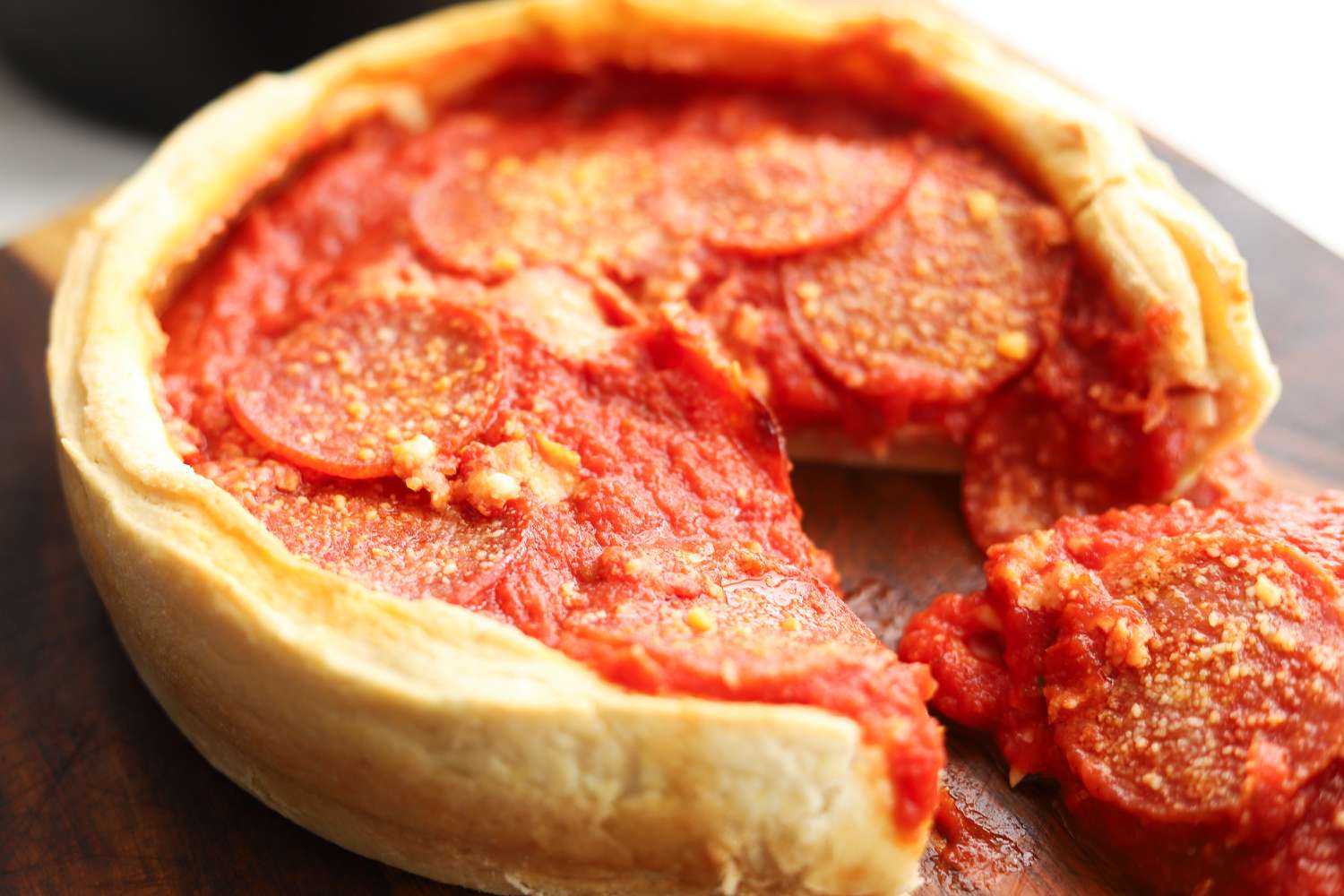 A closeup of a pizza made in the LloydPans Chicago Style Deep Dish Pizza Pan