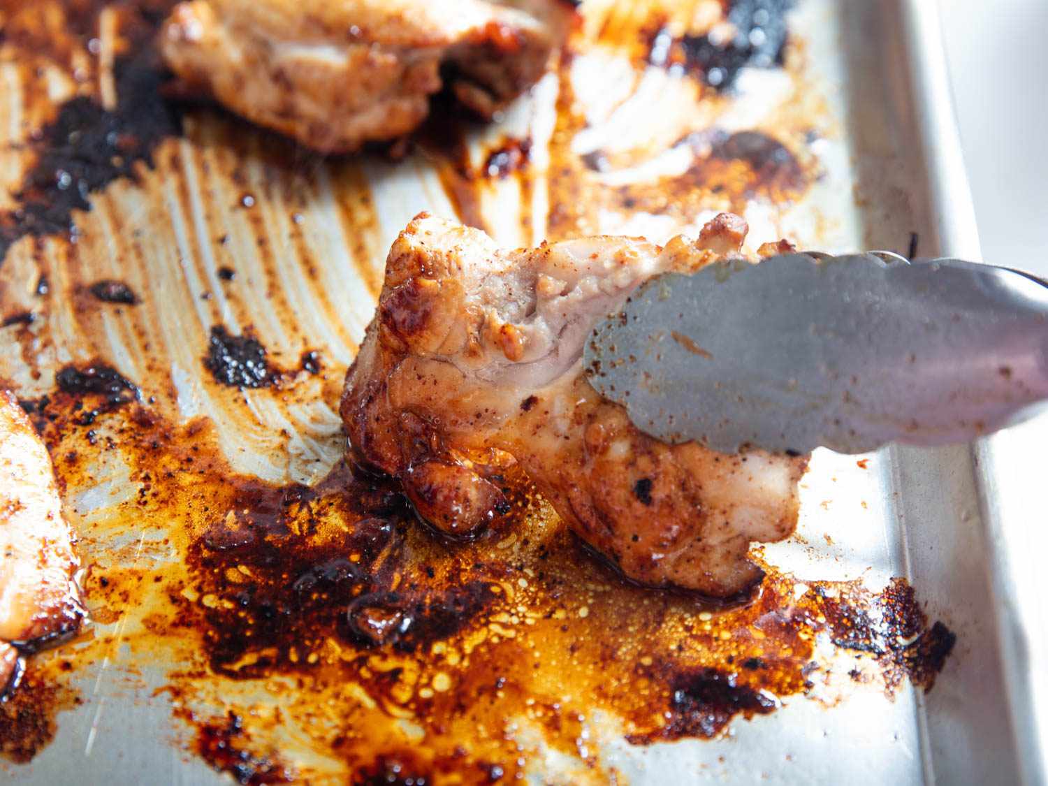 Chicken fajitas showing browning from a baking steel below
