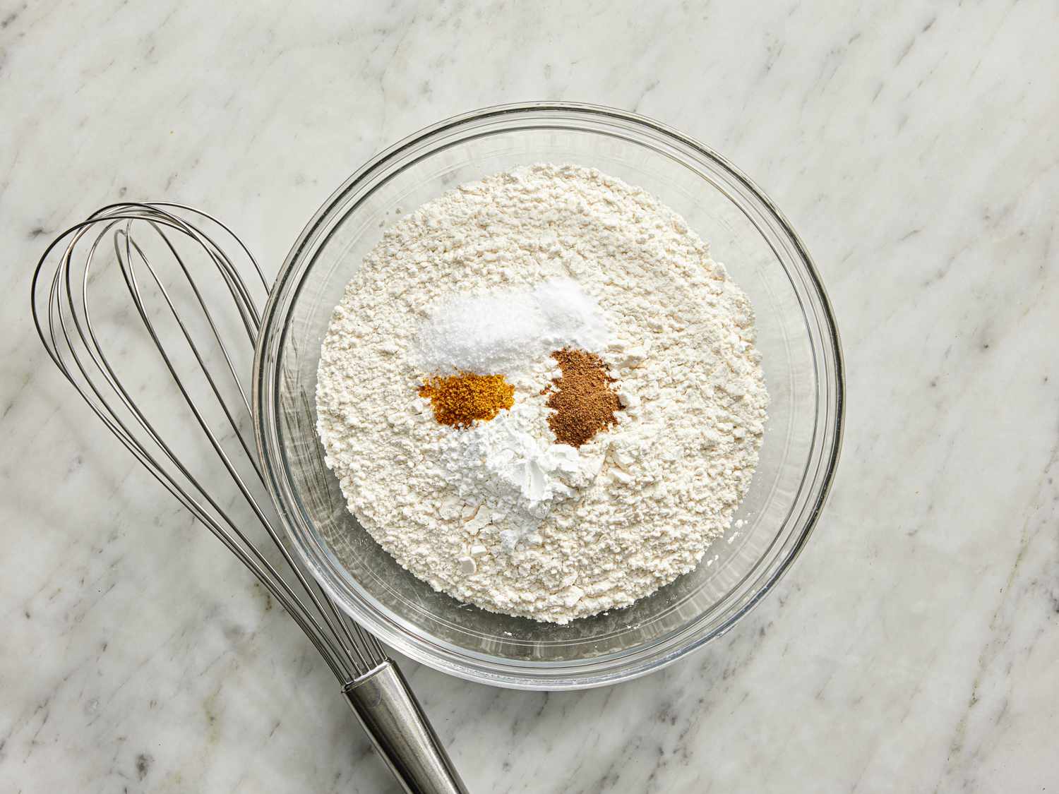 Overhead view of all dry ingredients in a bowl before being mixed