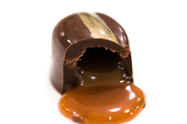 A half-bitten bonbons with melting caramel filling. 