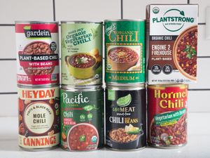 Various brands and types of canned vegetarian chili arranged in a group
