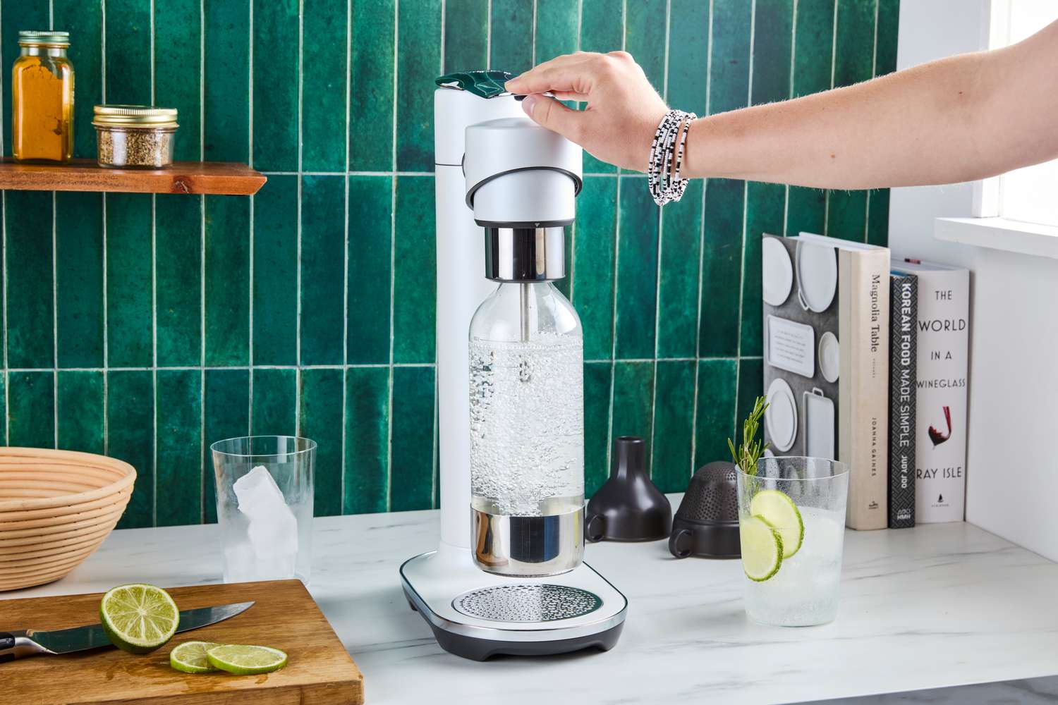 A person using the Breville soda maker to carbonate water.