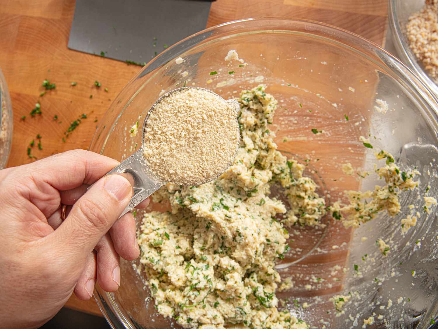 Adding bread crumbs to the canederli mixture to dry it