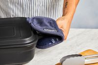 using the crate and barrel pot holder to grab the handle on a casserole dish