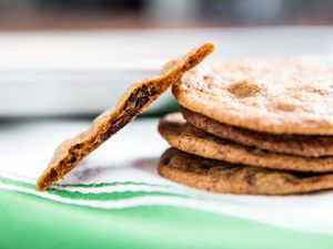 A stack of thin, crispy Tate's style chocolate chip cookies