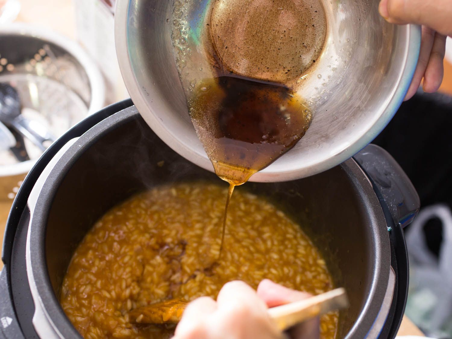 Stirring brown butter into risotto in a pressure cooker. 