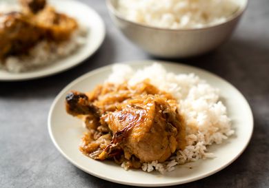 Chicken yassa on a bed of white rice.