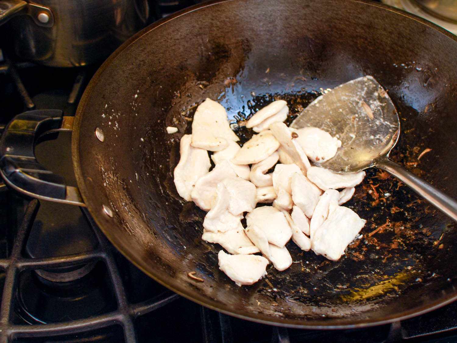 The water-velveted chicken is stir-fried in the wok.