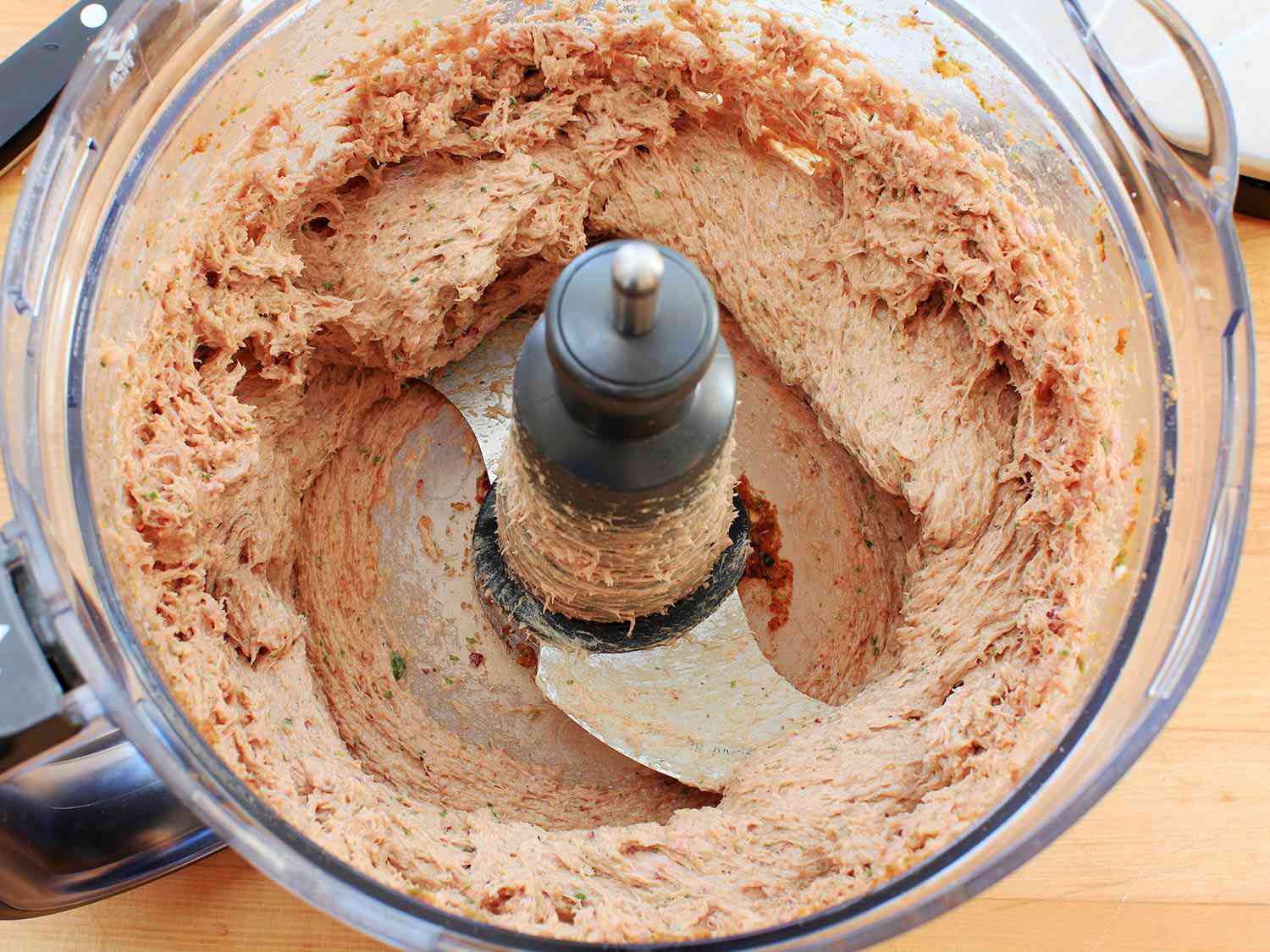 Seekh kebab meat mixture being pureed in a food processor. 